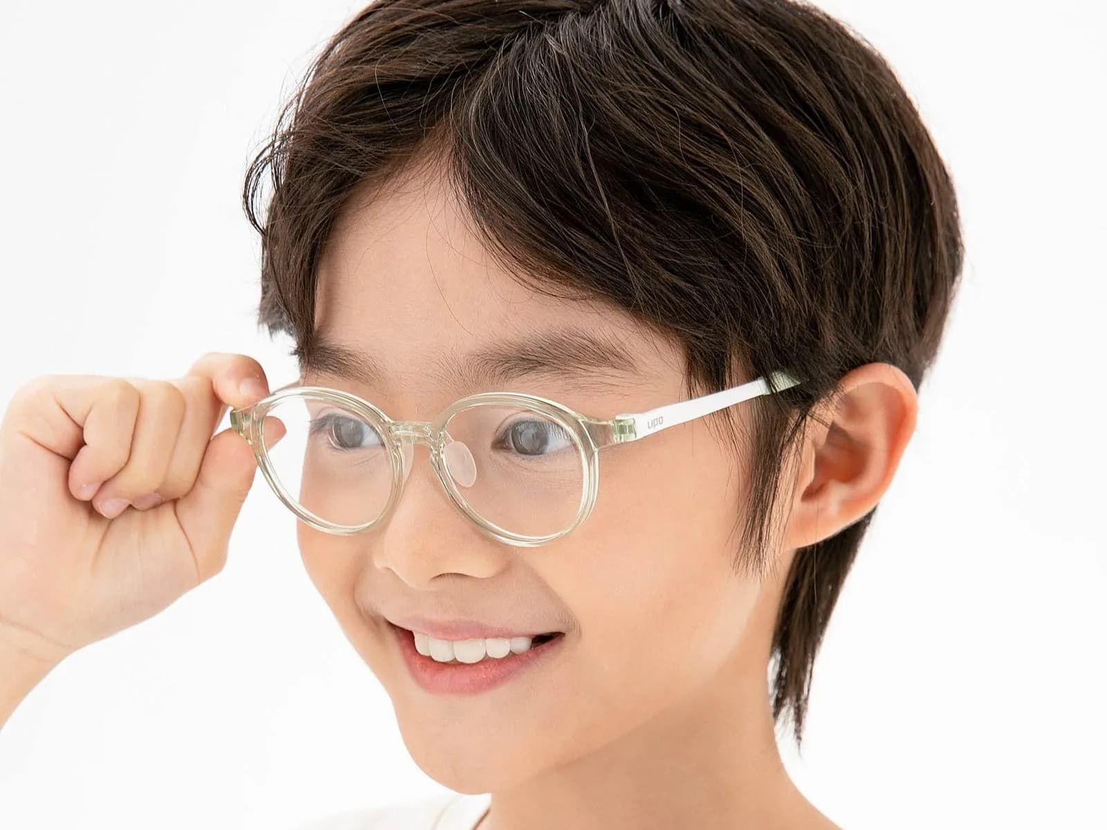 Boy wearing a clear LIPO CAI frame, adjusting it at the temple